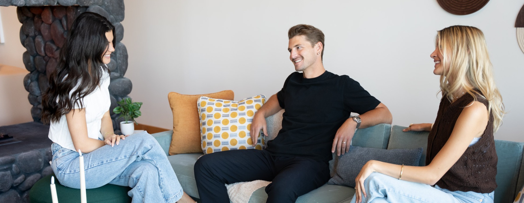 three people sitting down and smiling